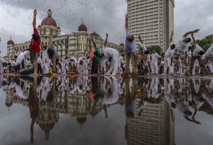 People perform Yoga to mark International Day of Yoga in front of Taj Mahal Palace hotel in Mumbai, India, Tuesday, June 21, 2022. Yoga enthusiasts across the world Tuesday took part in mass yoga events to mark Yoga Day. (AP Photo/Rafiq Maqbool)