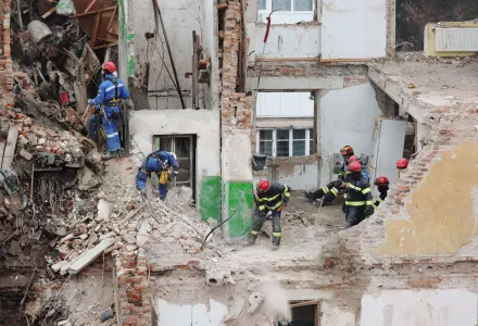 Rescue workers clear the rubble of a residential building which was heavily damaged by a Russian strike on Ternopil, Ukraine, Friday, Nov. 21, 2025.