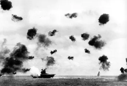 Smoke billows from the USS Yorktown and bursts from anti-aircraft fire fill the air after a Japanese bomber hit the aircraft carrier in the Battle of Midway near Midway Islands during World War II in June 1942.