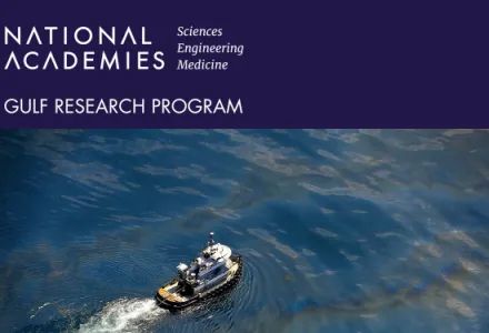 A boat moves through an oil spill.