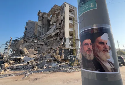 Posters of late Hezbollah leader Sayyed Hassan Nasrallah and the late Iranian revolutionary founder Ayatollah Khomeini, posted on a pole in front of a destroyed building in Beirut.