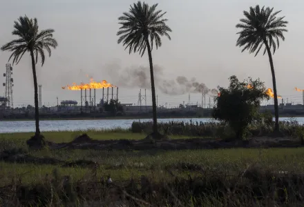 a landscape image of oil field flare stacks burning in Basra, Iraq
