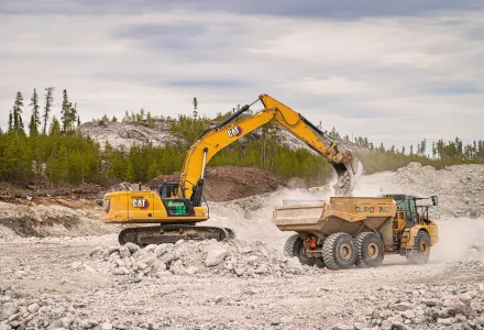 An excavator loads a dump truck with stone at Éléonore Mine in northern Quebec, May 18, 2023. 