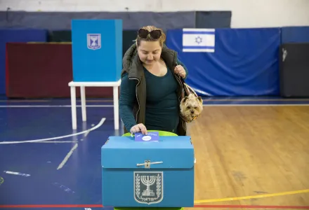 An Israeli woman casts her ballot for Israel's parliamentary election at a polling station in Ramat Gan, Israel, Tuesday, April 9, 2019