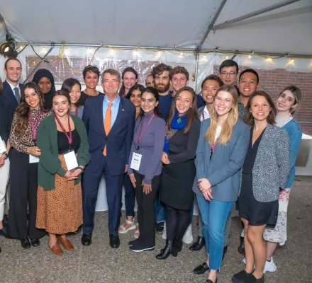 Ash Carter surrounded by student fellows ion a posed group photo.