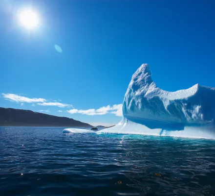 Sun shining over iceberg in the Arctic Ocean 