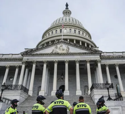 U.S. Capitol Police and NYPD officers stand in front of the Capitol, July 2024