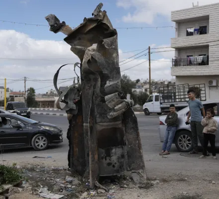 Palestinians inspect the debris of an Iranian missile intercepted by Israel, in the West Bank city of Hebron, Oct. 2, 2024. (AP Photo/Mahmoud Illean)