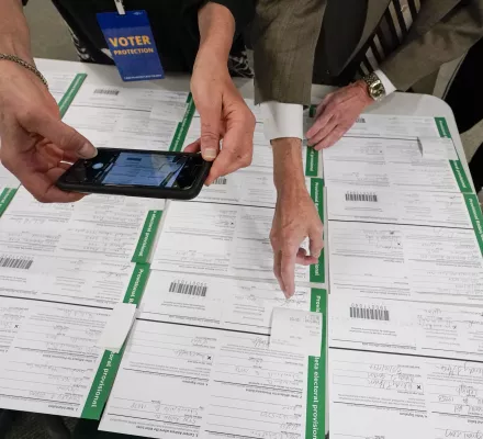 FILE - A canvas observer photographs Lehigh County provisional ballots as vote counting in the general election continues, Nov. 6, 2020, in Allentown, Pa. (AP Photo/Mary Altaffer, File)