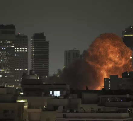 An explosion is seen during a missile attack in Tel Aviv, Israel, Sunday, June 15, 2025.