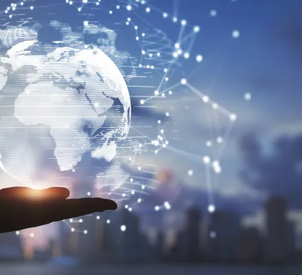 A hand beneath a glowing stylized version of the globe