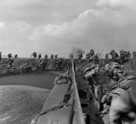 In the Pacific theater of World War II, U.S. Marines hit the beach and charge over a dune on Iwo Jima in the Volcano Islands Feb. 19, 1945, the start of one of the deadliest battles of the war against Japan.
