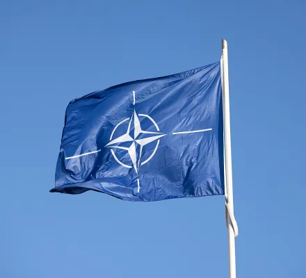 NATO Flag against a blue sky