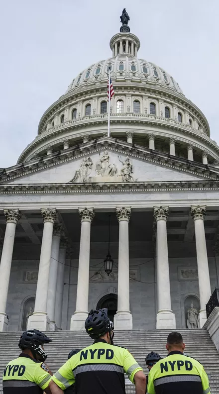U.S. Capitol Police and NYPD officers stand in front of the Capitol, July 2024