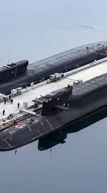 FILE - In this photo released by the Russian Defense Ministry Press Service, the Russian nuclear submarines Prince Vladimir, above, and Yekaterinburg are harbored at a naval base in Gazhiyevo, on the Kola Peninsula in Russia, on April 13, 2021. Russian hawks have called for revising the country's nuclear doctrine to lower the threshold for the use of nuclear weapons, and President Vladimir Putin said the doctrine could be modified. (Russian Defense Ministry Press Service via AP, File)
