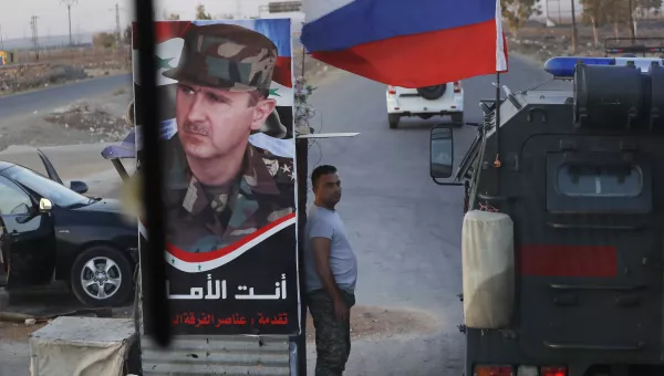 Syrian army soldier stands at a check-point 