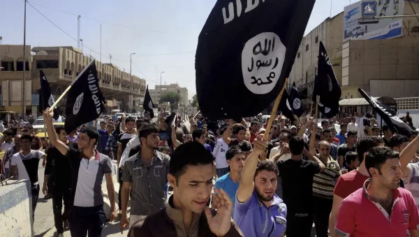 Demonstrators chant pro-Islamic State group slogans as they wave the group's flags in front of the provincial government headquarters in Mosul, 225 miles (360 kilometers) northwest of Baghdad, Iraq, Monday, June 16, 2014. 