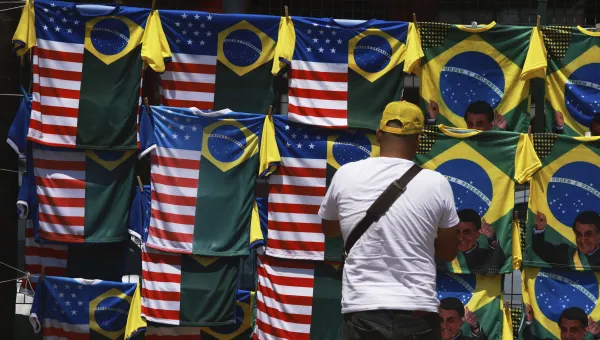 A vendor displays dual flag jerseys featuring the Brazilian and U.S. flag, outside the condominium where former President Jair Bolsonaro is under house arrest in Brasilia