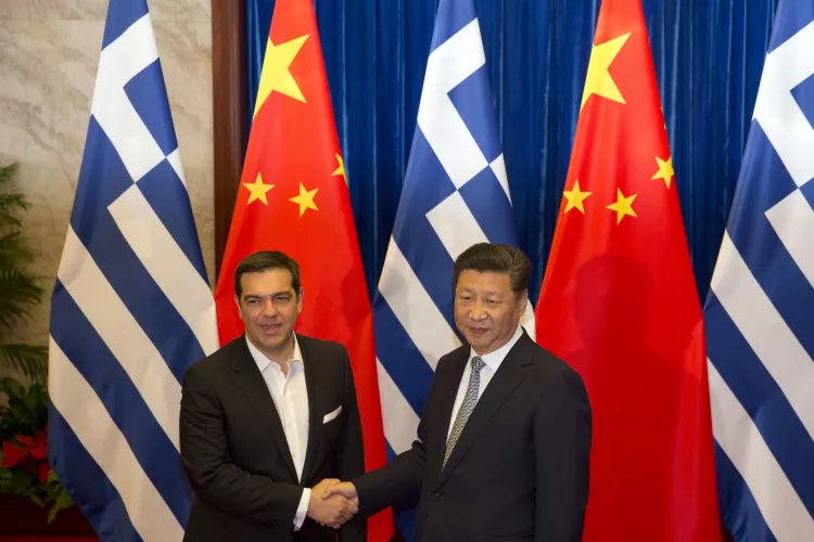 Greek Prime Minister Alexis Tsipras, left shakes hands with Chinese President Xi Jinping during a meeting at the Great Hall of the People in Beijing, China on July 5, 2016 (AP Photo/Ng Han Guan, Pool).