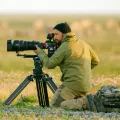 Florian Schulz kneels to take a photograph.