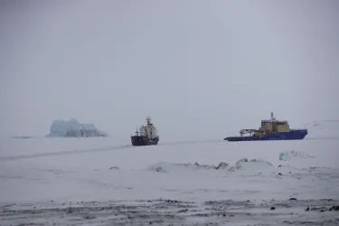 An icebreaker makes a path for a cargo ship near Nagurskoye, Russia, May 17, 2021.